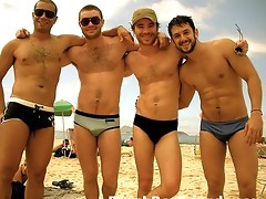 Camera loving beach boys showing off their great assets