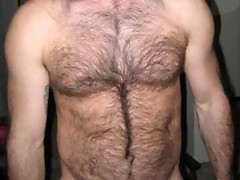 Topless dude showing off his hairy chest and flexing muscles