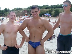 Hunk boys with big muscles posing topless at the beach